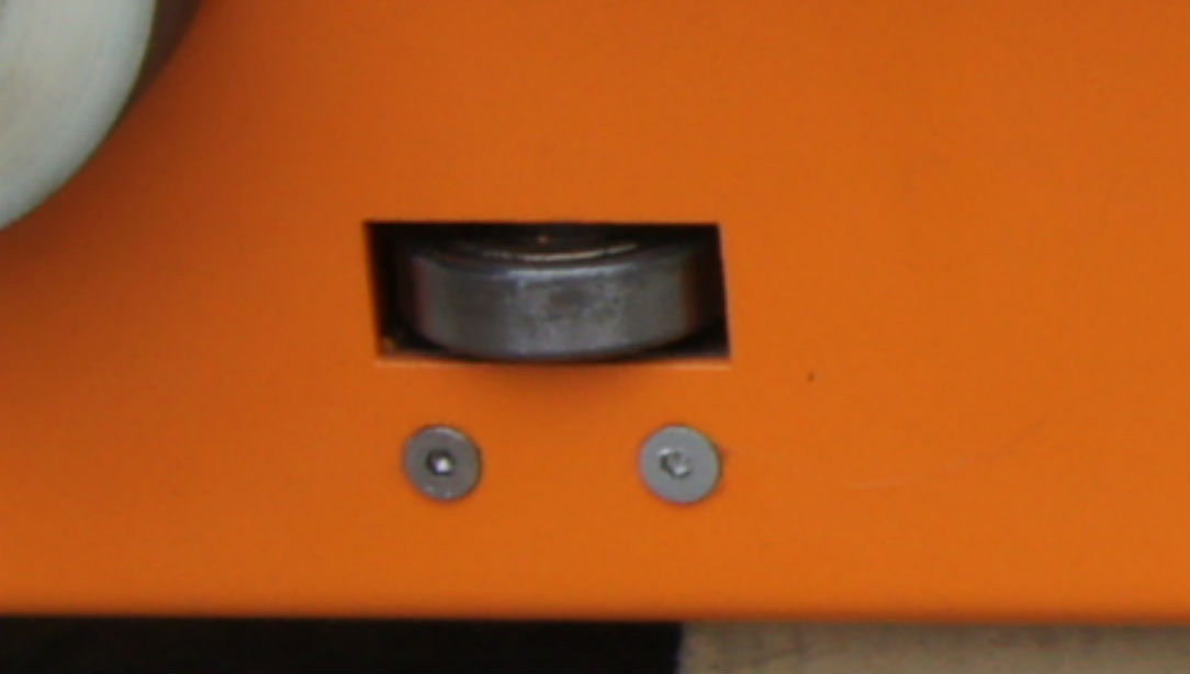 Image of guide wheel to center Pallet Shuttle within a channel.